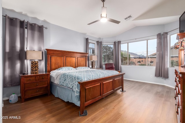 bedroom featuring vaulted ceiling, light hardwood / wood-style floors, and ceiling fan