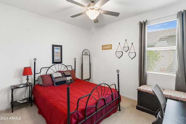 bedroom featuring ceiling fan, baseboards, and light carpet