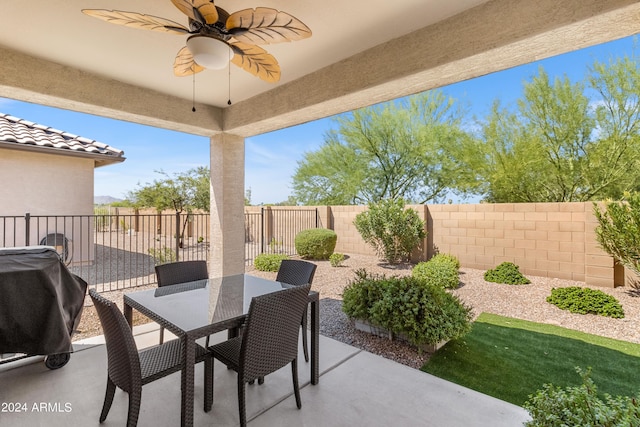 view of patio featuring a grill, a ceiling fan, outdoor dining area, and a fenced backyard