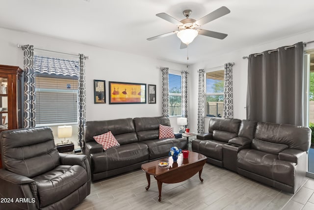 living area featuring ceiling fan and wood tiled floor