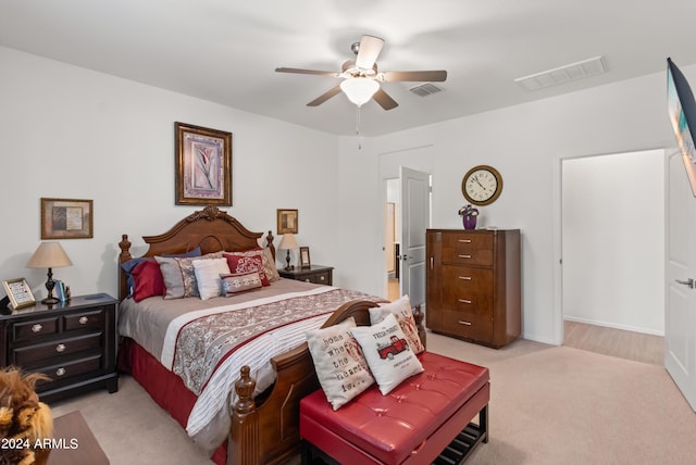 bedroom featuring visible vents, light carpet, and a ceiling fan