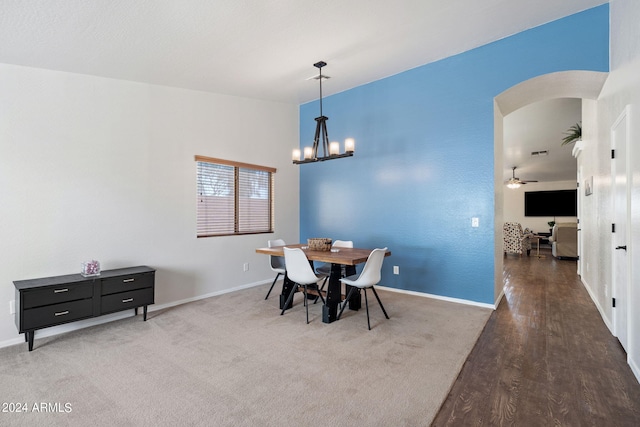 dining area featuring wood-type flooring and a chandelier