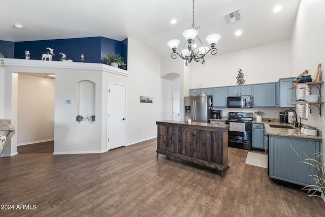 kitchen featuring sink, high vaulted ceiling, pendant lighting, dark stone counters, and black appliances