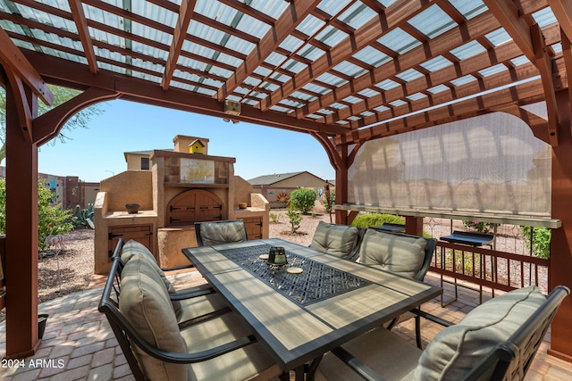 view of patio with an outdoor fireplace and a pergola