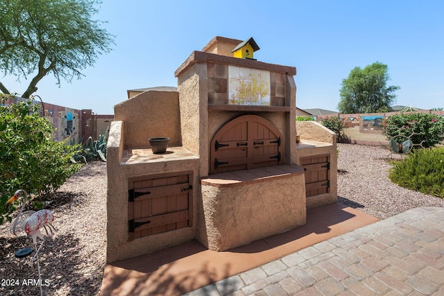 view of patio with an outdoor fireplace