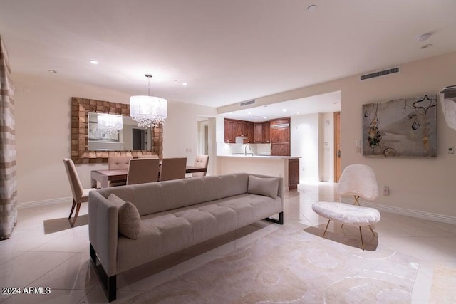 tiled living room featuring a chandelier and sink