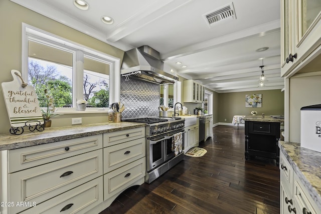 kitchen with range with two ovens, visible vents, wall chimney range hood, beam ceiling, and dark wood-style floors