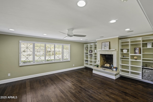 unfurnished living room with crown molding, baseboards, a fireplace, and hardwood / wood-style floors