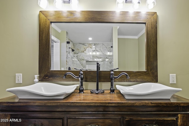 bathroom with double vanity, ornamental molding, a sink, and a marble finish shower