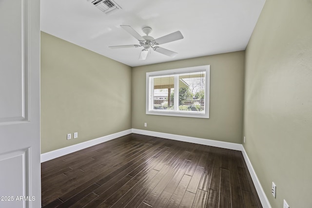 empty room with a ceiling fan, dark wood finished floors, visible vents, and baseboards