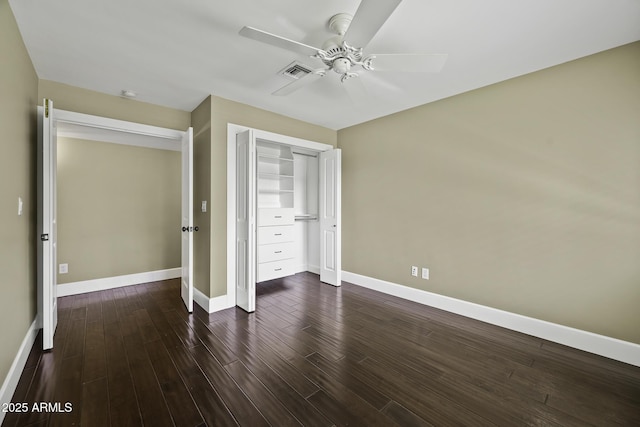 unfurnished bedroom with baseboards, a closet, visible vents, and dark wood-style flooring