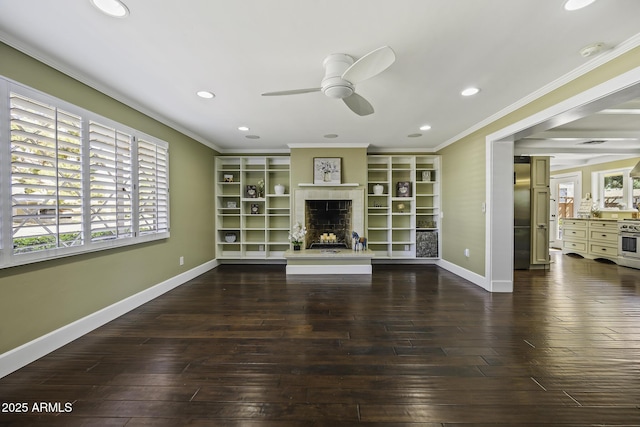 unfurnished living room with a fireplace with raised hearth, wood-type flooring, and crown molding