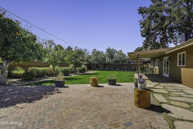 view of patio with a fenced backyard and central AC