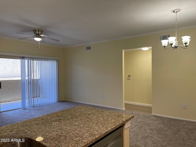 carpeted spare room with ceiling fan with notable chandelier and crown molding