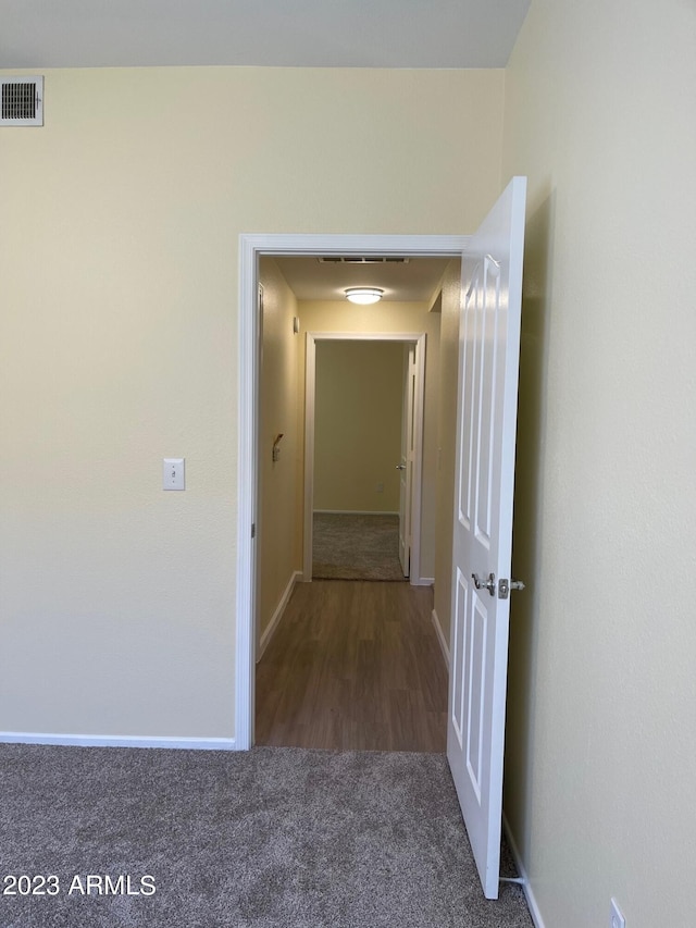 corridor with dark colored carpet