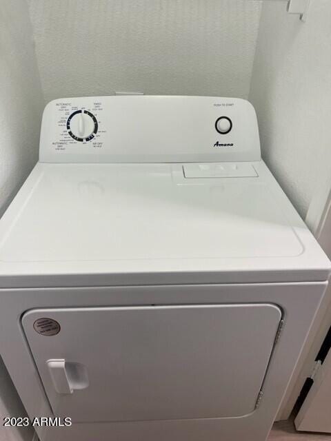 clothes washing area featuring washer / dryer