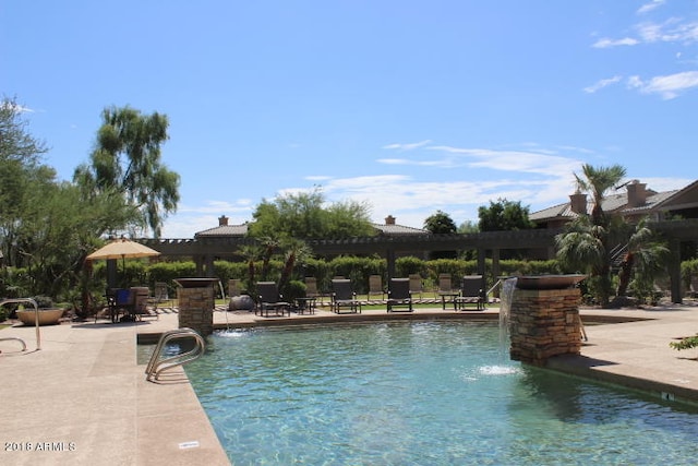 view of pool with a patio and pool water feature