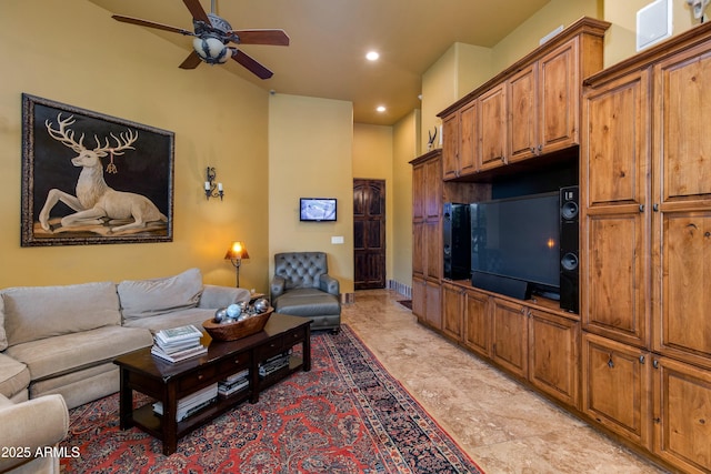 living area featuring recessed lighting, baseboards, and ceiling fan