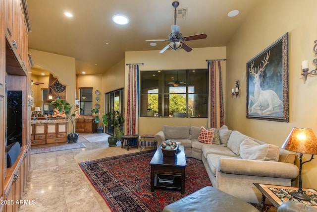 living area featuring visible vents, recessed lighting, and a ceiling fan