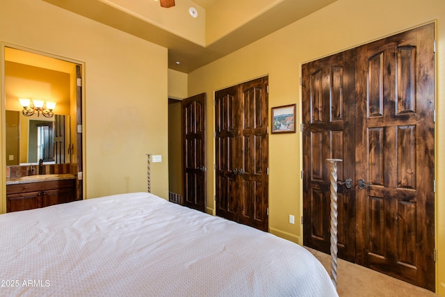 bedroom featuring connected bathroom and carpet