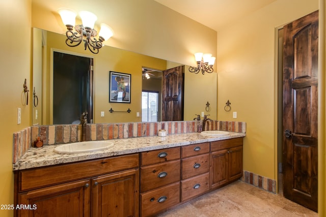 bathroom with a chandelier, tile patterned floors, double vanity, and a sink