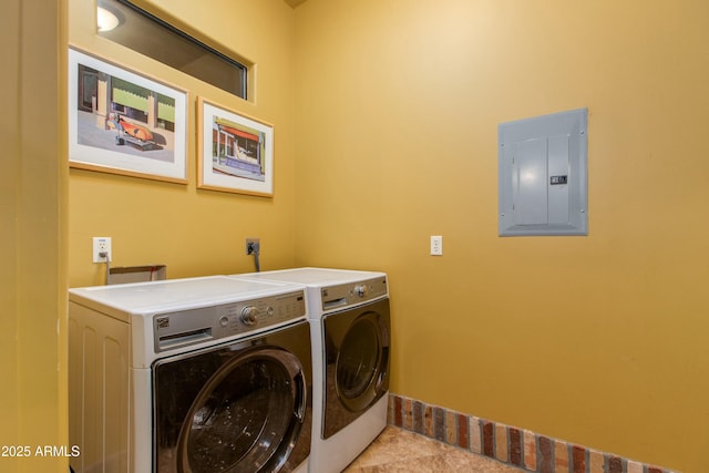 laundry room with electric panel, laundry area, washing machine and dryer, and tile patterned floors