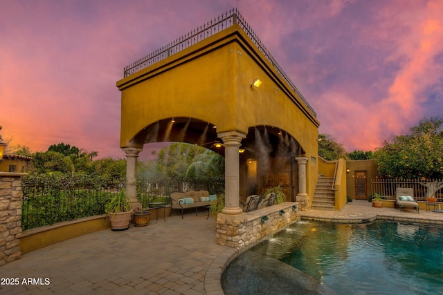 exterior space with an outdoor living space, fence, and a fenced in pool