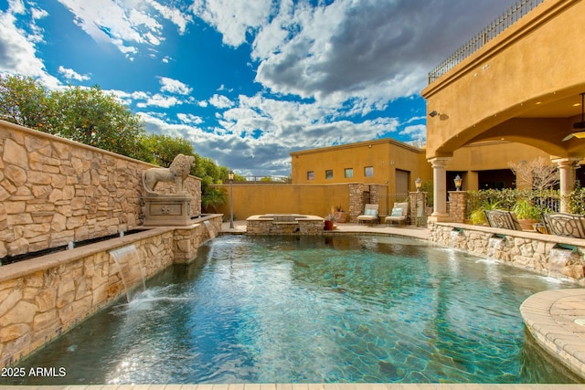 view of pool featuring a pool with connected hot tub and fence