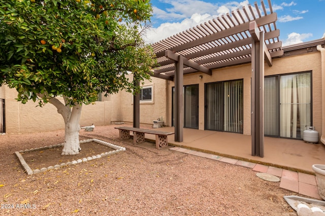 exterior space with stucco siding and a pergola