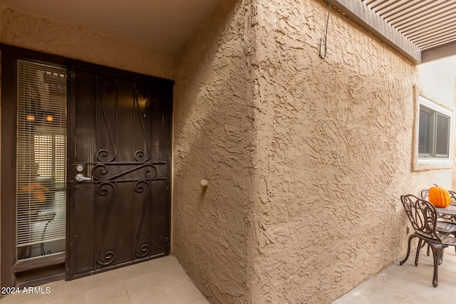 doorway to property featuring stucco siding