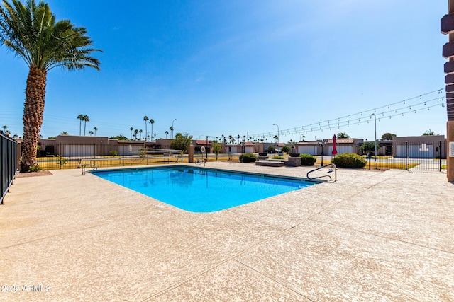 community pool featuring a patio area and fence