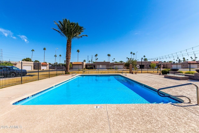 pool featuring a patio area and fence