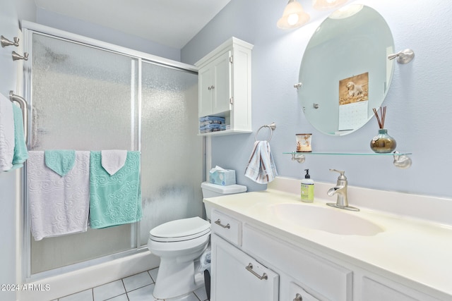 bathroom featuring walk in shower, tile patterned flooring, vanity, and toilet