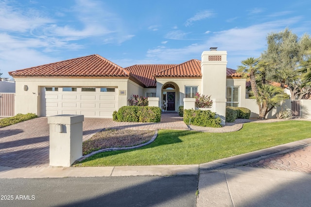 mediterranean / spanish house featuring decorative driveway, a tile roof, an attached garage, and stucco siding