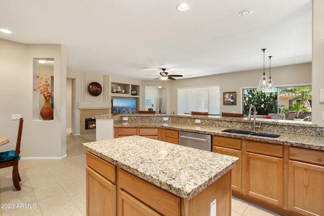 kitchen with ceiling fan, dishwasher, sink, a center island, and pendant lighting