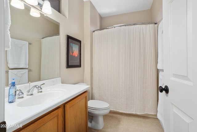 bathroom featuring toilet, vanity, and tile patterned floors