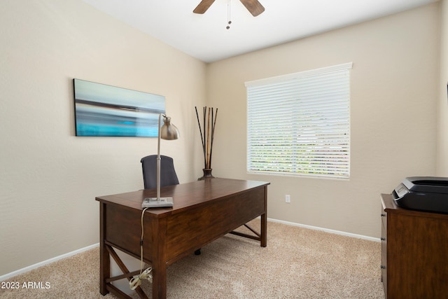 office space featuring light carpet and ceiling fan