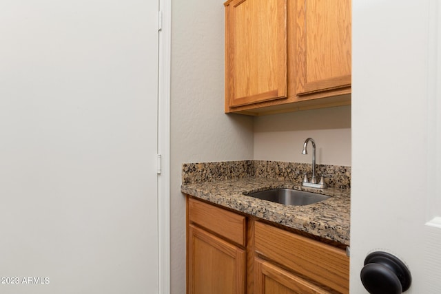 kitchen with stone countertops and sink