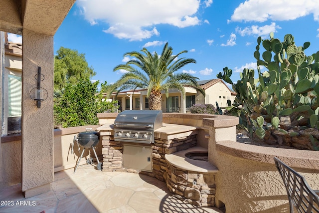 view of patio / terrace with an outdoor kitchen and a grill