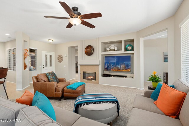 carpeted living room featuring ceiling fan