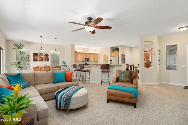 tiled living room with ceiling fan