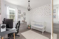 bedroom with a nursery area and radiator