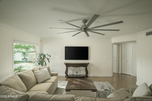 living room with ornamental molding, a ceiling fan, baseboards, and dark wood-style floors