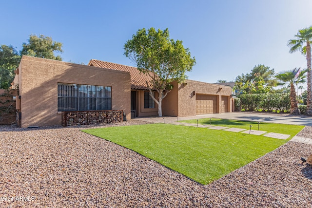 view of front of house with a front yard and a garage