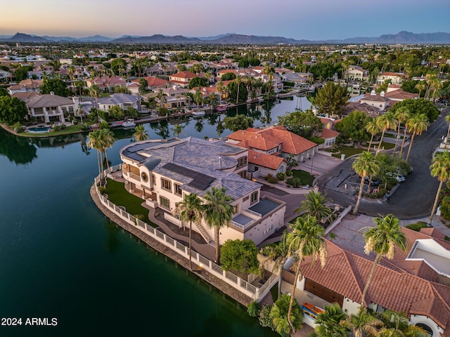 aerial view at dusk with a water view