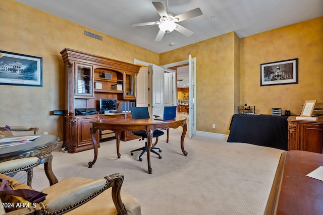 carpeted office with ceiling fan