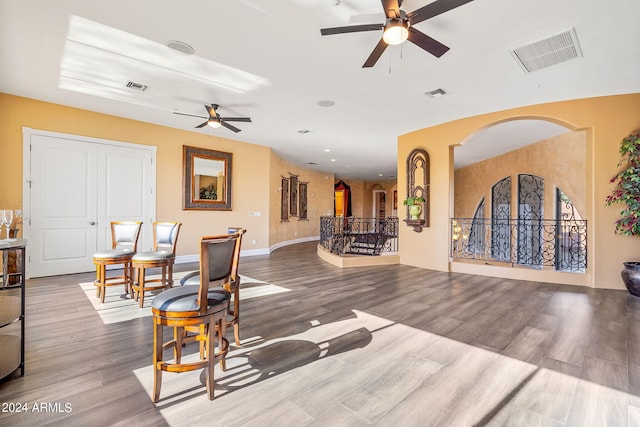 living room featuring hardwood / wood-style floors and ceiling fan