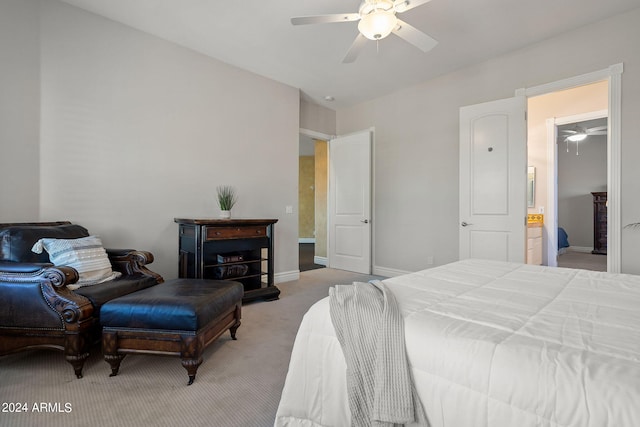 bedroom with ceiling fan, ensuite bathroom, and light carpet