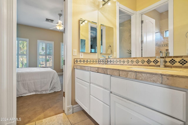 bathroom with tile patterned flooring, vanity, tasteful backsplash, and ceiling fan