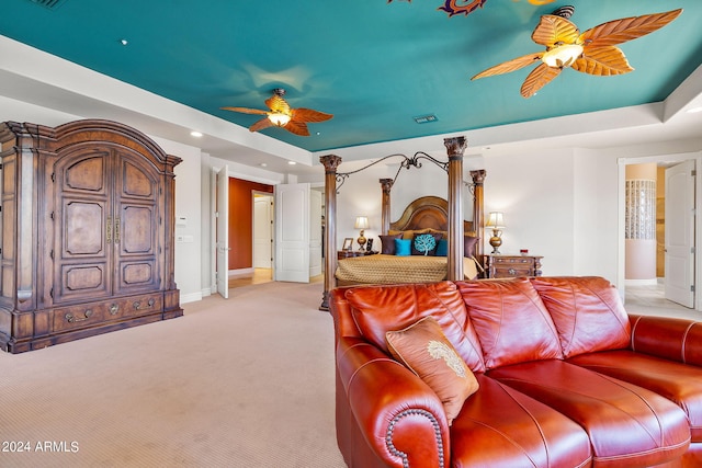 carpeted bedroom featuring ceiling fan and ensuite bath